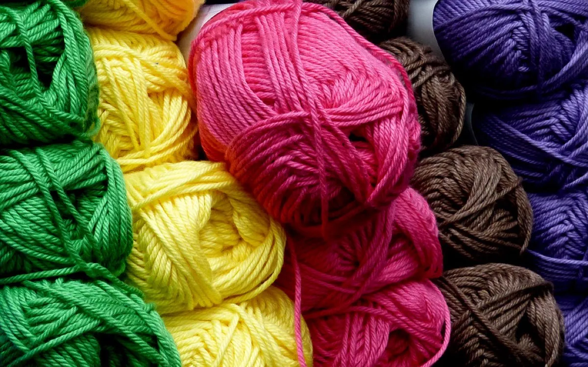 Balls of wool in bright green, yellow, pink, purple and brown